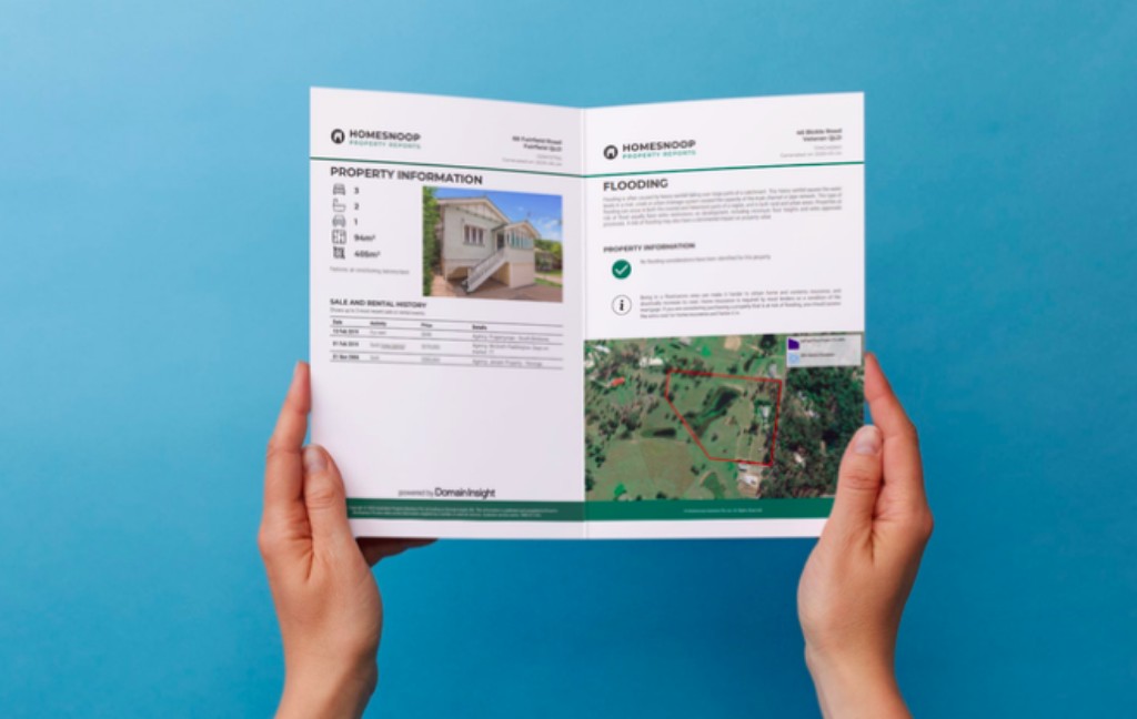 Mortgage broker reviewing a Homesnoop property report with a client
